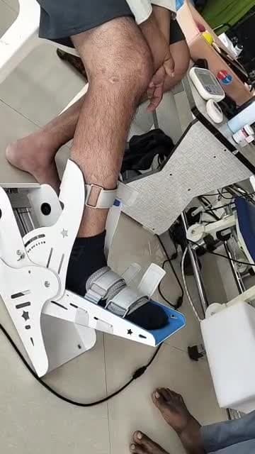 Patient using robotic ankle rehabilitation device